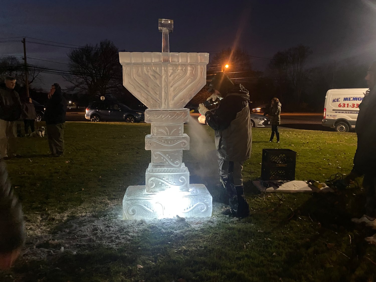 The finished ice menorah after being lit.